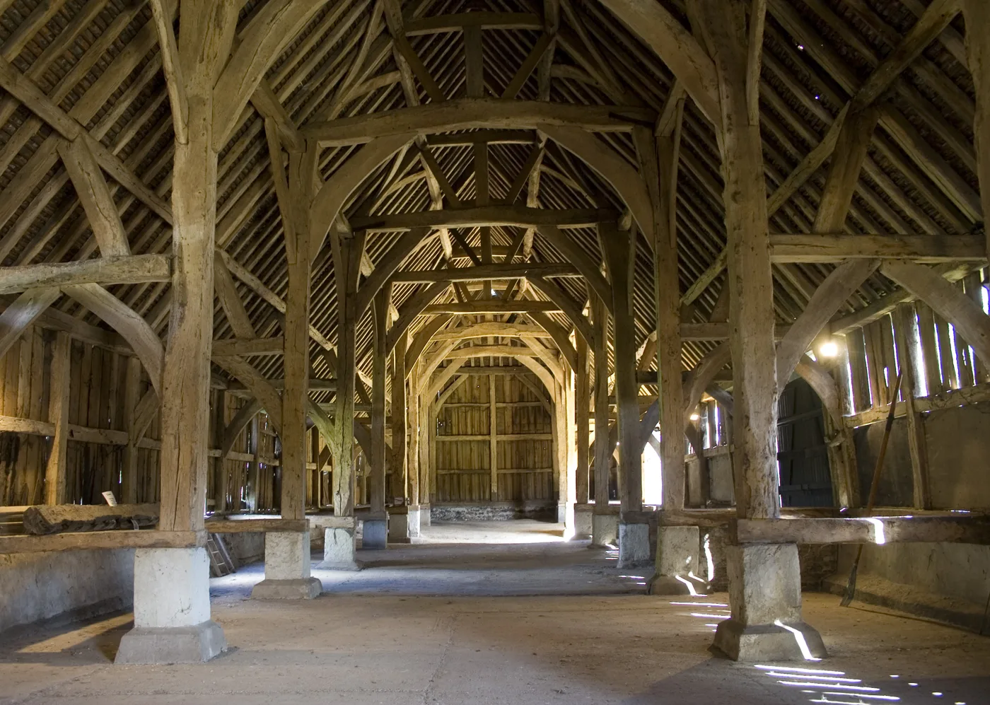 Inside the Great Barn at Harmondsworth. Thirteen oak trusses carry the roof over a nave and two aisles, the shape that earned it the nickname Cathedral of Middlesex